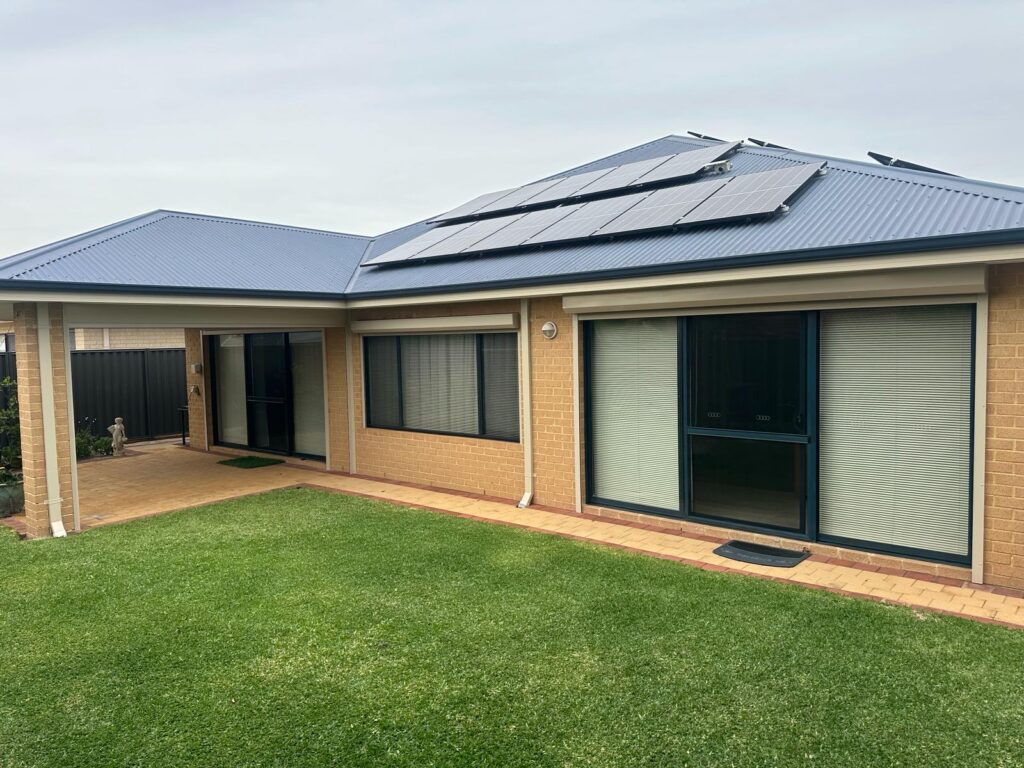 home featuring beige roller shutters installed on large sliding glass doors and windows
