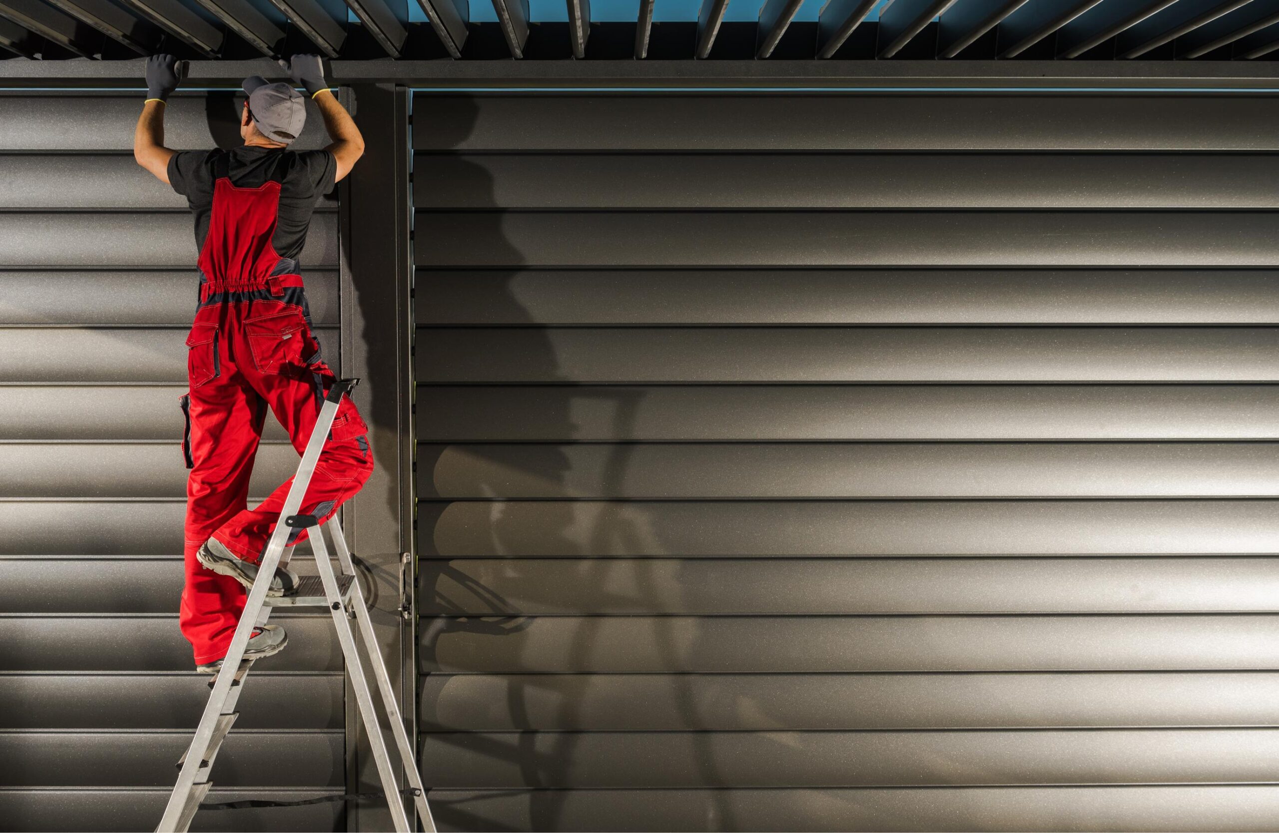 Technician performing roller shutters servicing on roller shutters